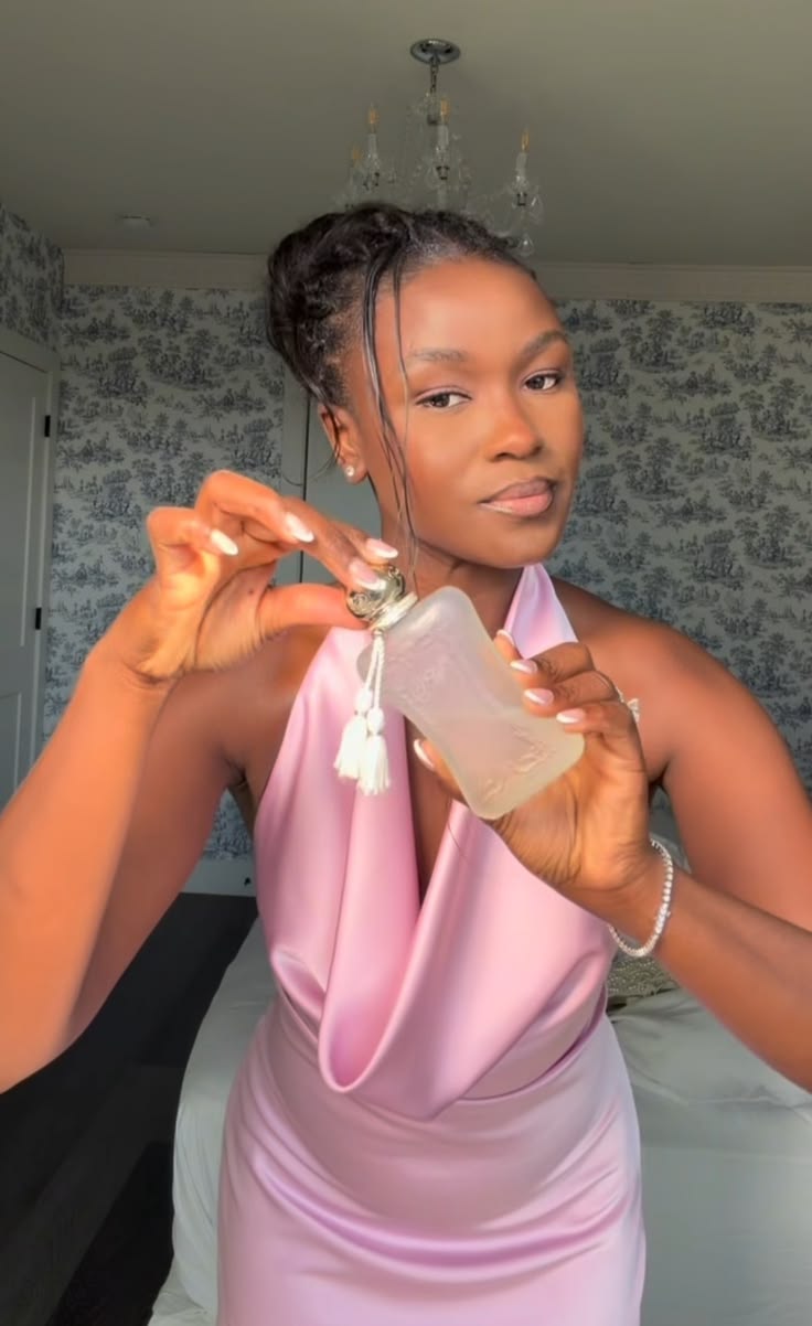 Black woman applying deodorant and perfume getting ready