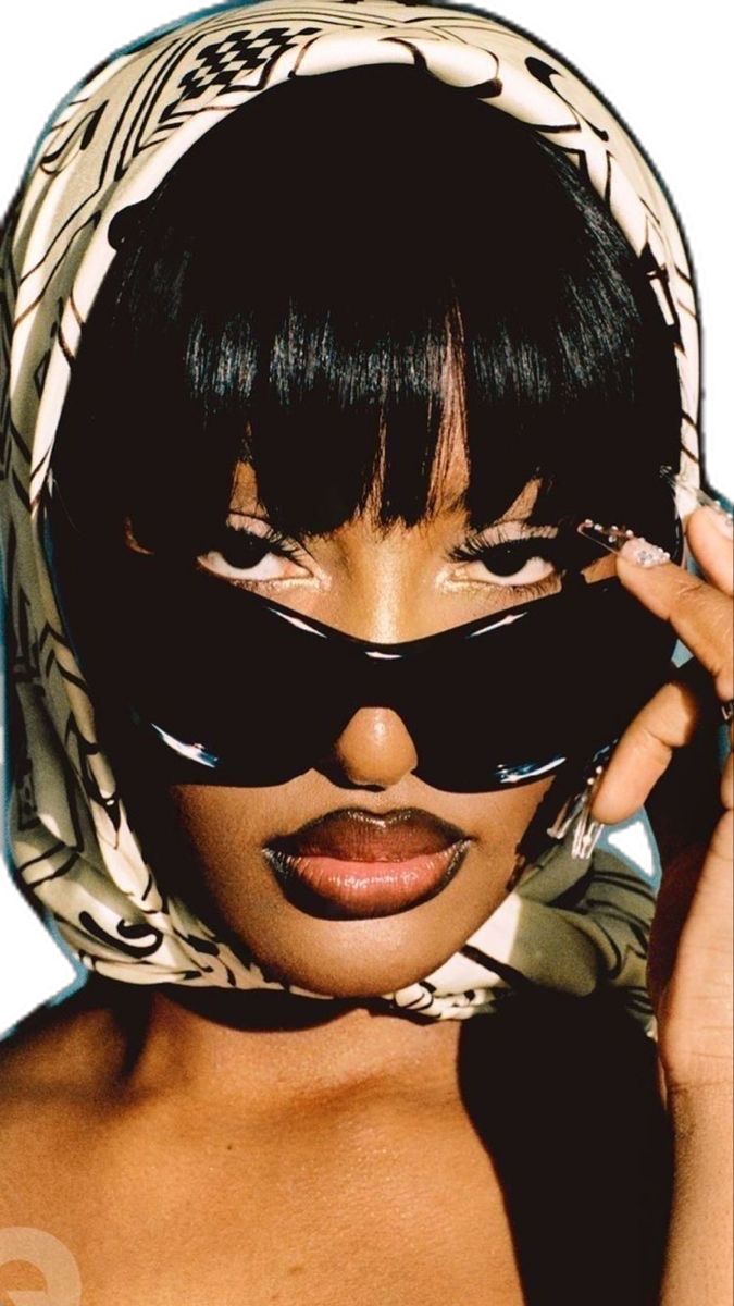 Woman wearing oversized statement sunglasses with a contemporary outfit