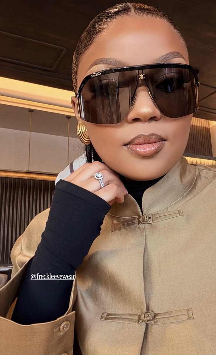Woman wearing oversized statement sunglasses with a contemporary outfit