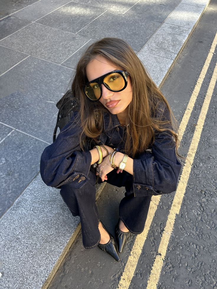 Woman wearing oversized statement sunglasses with a contemporary outfit