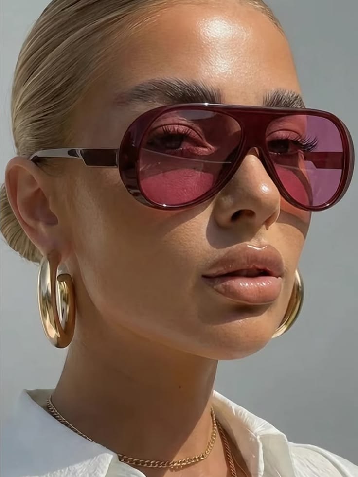 Woman wearing oversized statement sunglasses with a contemporary outfit