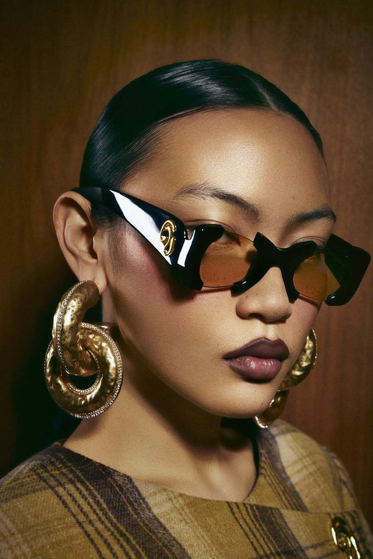Woman wearing oversized statement sunglasses with a contemporary outfit