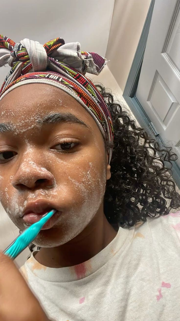 Black woman brushing teeth morning routine