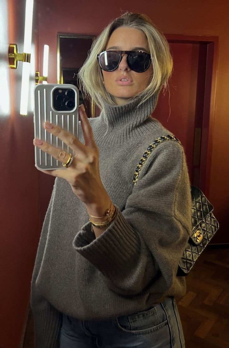 Woman wearing oversized statement sunglasses with a contemporary outfit