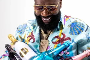 Rick Ross holding a Belaire bottle and Rick Ross speaks about Tanzania and his big ideas with Paul Makonda