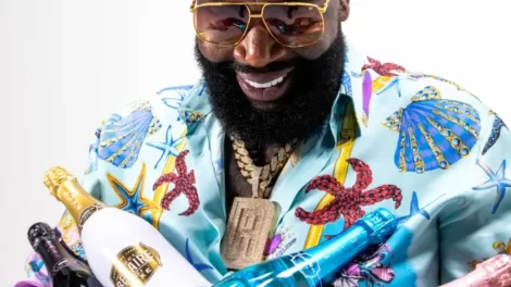 Rick Ross holding a Belaire bottle and Rick Ross speaks about Tanzania and his big ideas with Paul Makonda