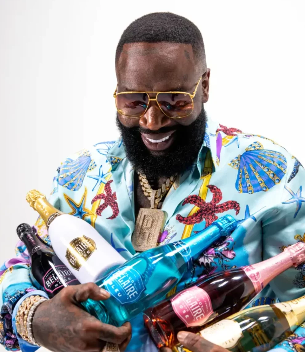 Rick Ross holding a Belaire bottle and Rick Ross speaks about Tanzania and his big ideas with Paul Makonda