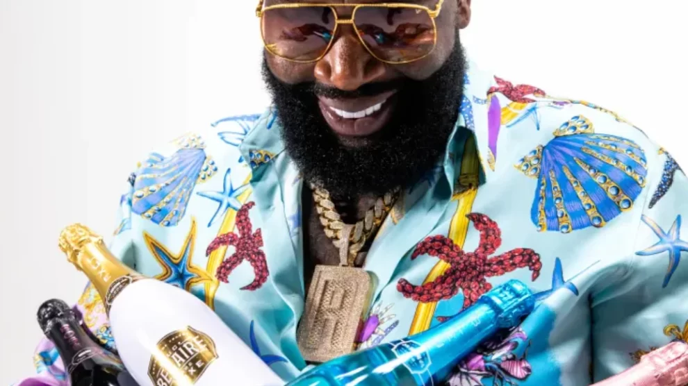Rick Ross holding a Belaire bottle and Rick Ross speaks about Tanzania and his big ideas with Paul Makonda