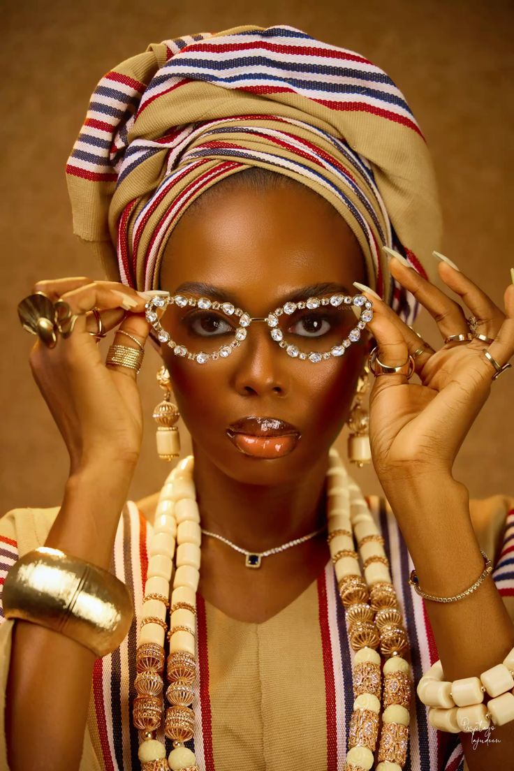 Nigerian fashion look featuring statement sunglasses, Aso-Oke and coral beads